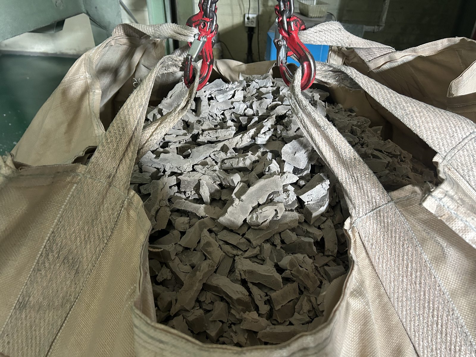 Crushed rubber pieces in a bulk bag.