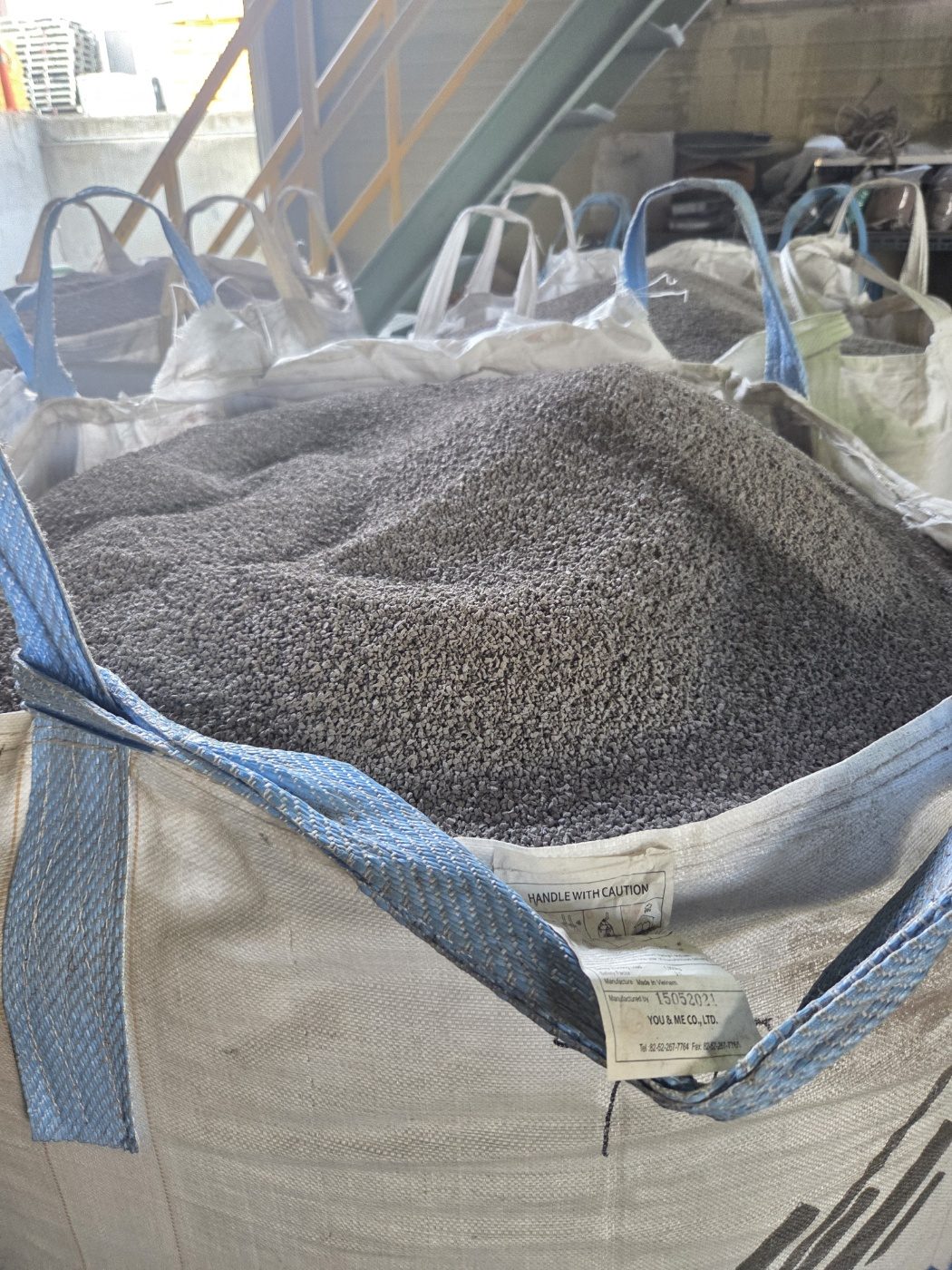 A bulk bag full of fine rubber granules.