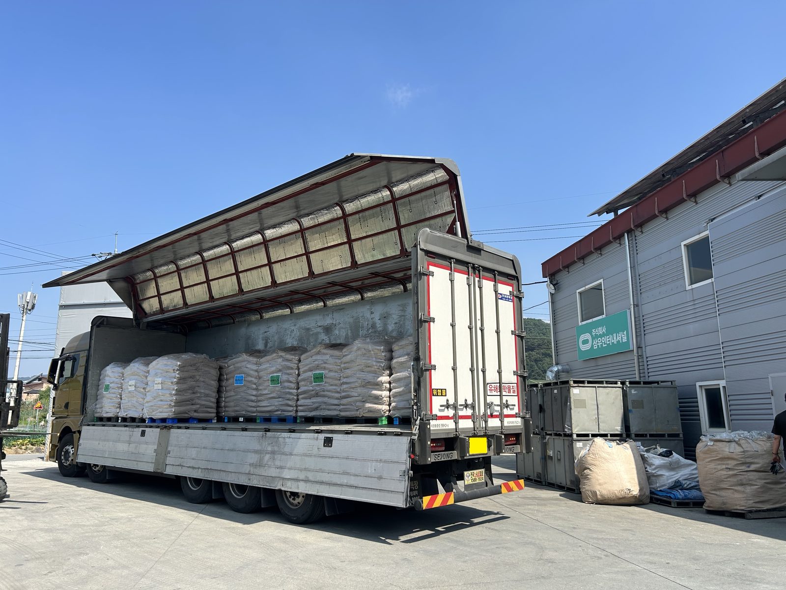 A truck loaded with bagged rubber granules at the factory.